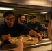 U.S. Coast Guard Cutter Stratton culinary specialists prepare lunch while transiting on the Pacific Ocean