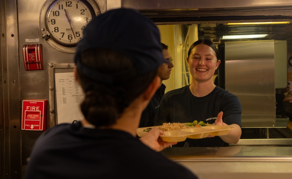 U.S. Coast Guard Cutter Stratton culinary specialists prepare lunch while transiting on the Pacific Ocean