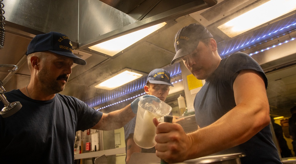 U.S. Coast Guard Cutter Stratton culinary specialists prepare lunch while transiting on the Pacific Ocean