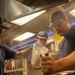 U.S. Coast Guard Cutter Stratton culinary specialists prepare lunch while transiting on the Pacific Ocean