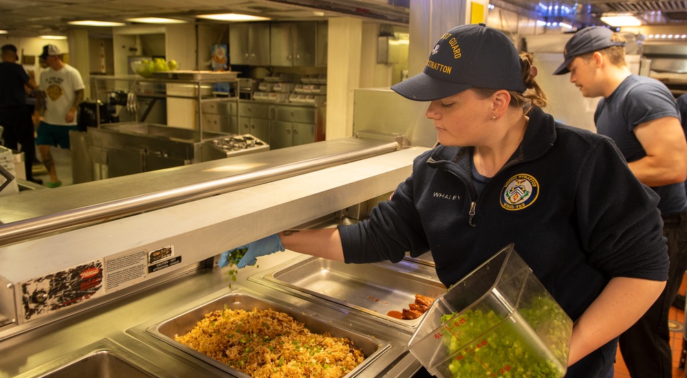 U.S. Coast Guard Cutter Stratton culinary specialists prepare lunch while transiting on the Pacific Ocean
