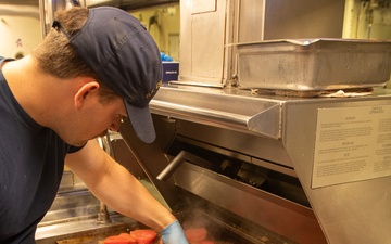 U.S. Coast Guard Cutter Stratton culinary specialists prepare lunch while transiting on the Pacific Ocean