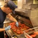 U.S. Coast Guard Cutter Stratton culinary specialists prepare lunch while transiting on the Pacific Ocean