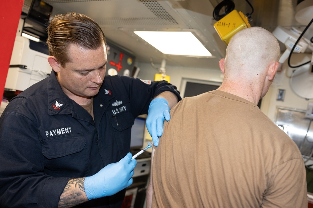 Curtis Wilbur Sailors Administers Vaccination
