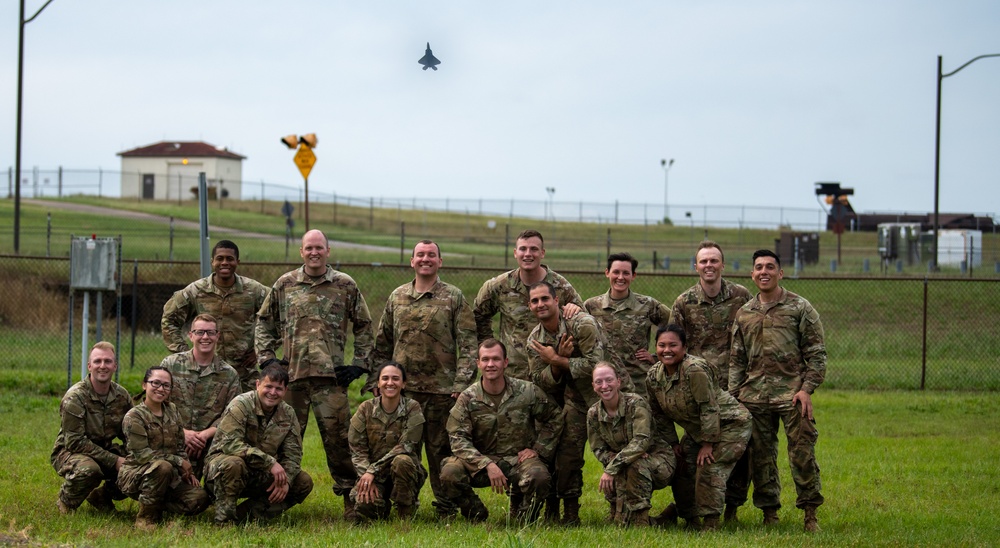 OTS Class 25-13 Marks Milestone with Flight Photo During F-22 Flyover