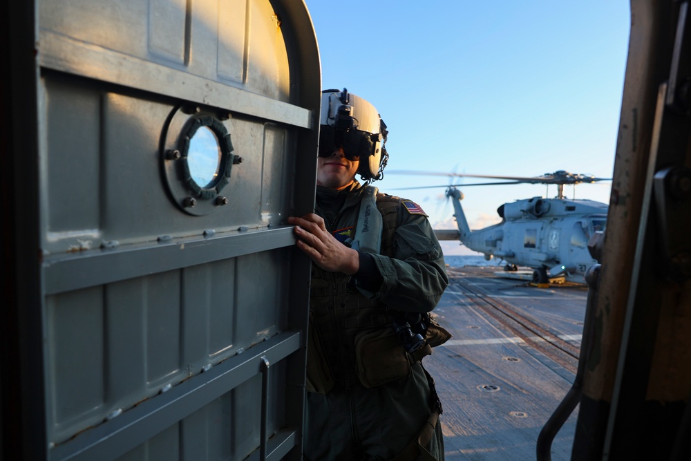 Lt. Albert Femmer proceeds to the launch of a MH-60R Sea Hawk helicopter during Formidable Shield (FS) 2025