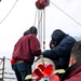 U.S. Navy Sailors hoist a torpedo into its launcher during Formidable Shield (FS) 2025