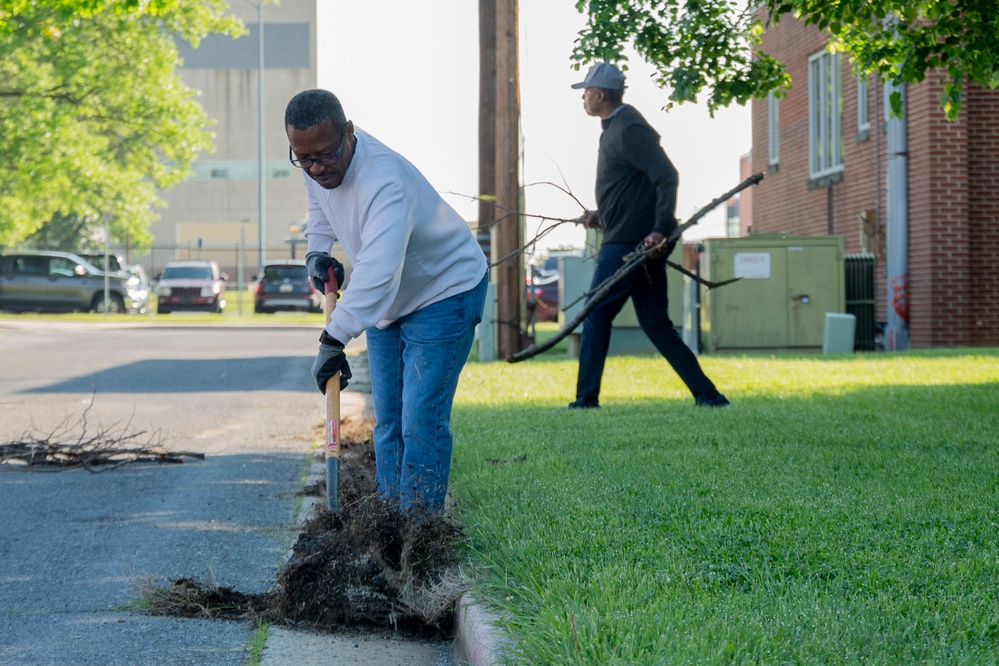 Team members with Operational Medical Systems participate in spring clean-up