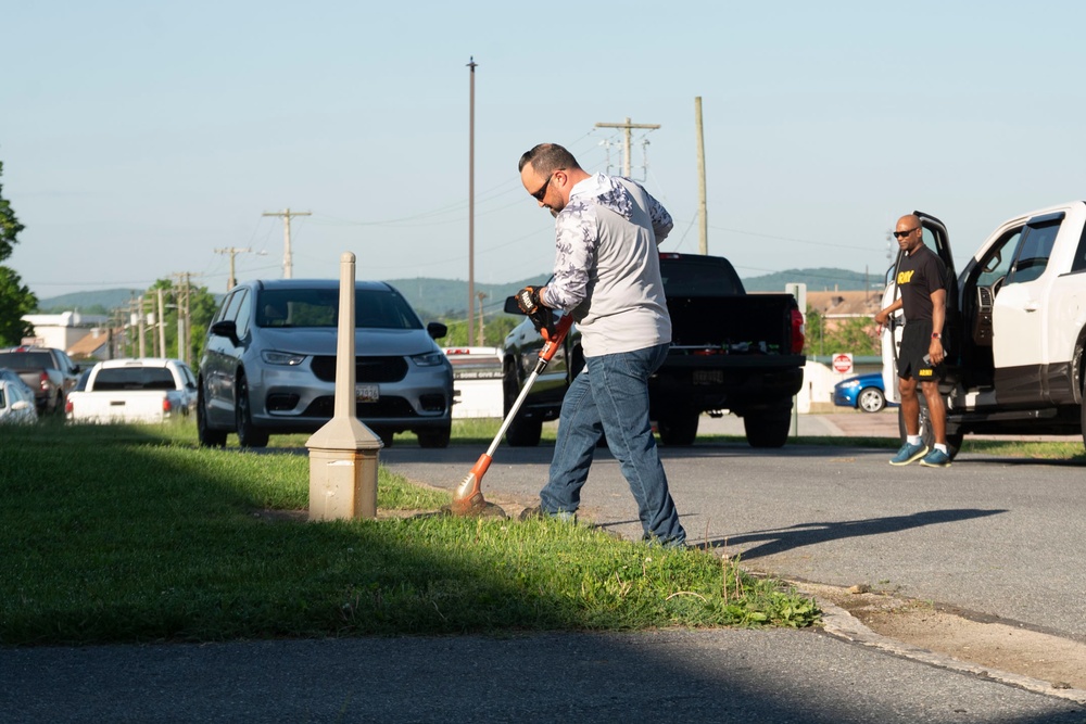 Team members with Operational Medical Systems participate in spring clean-up