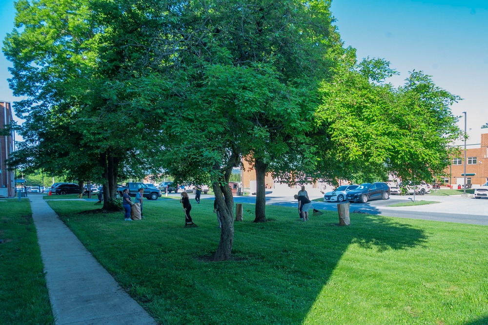 Team members with Operational Medical Systems participate in spring clean-up