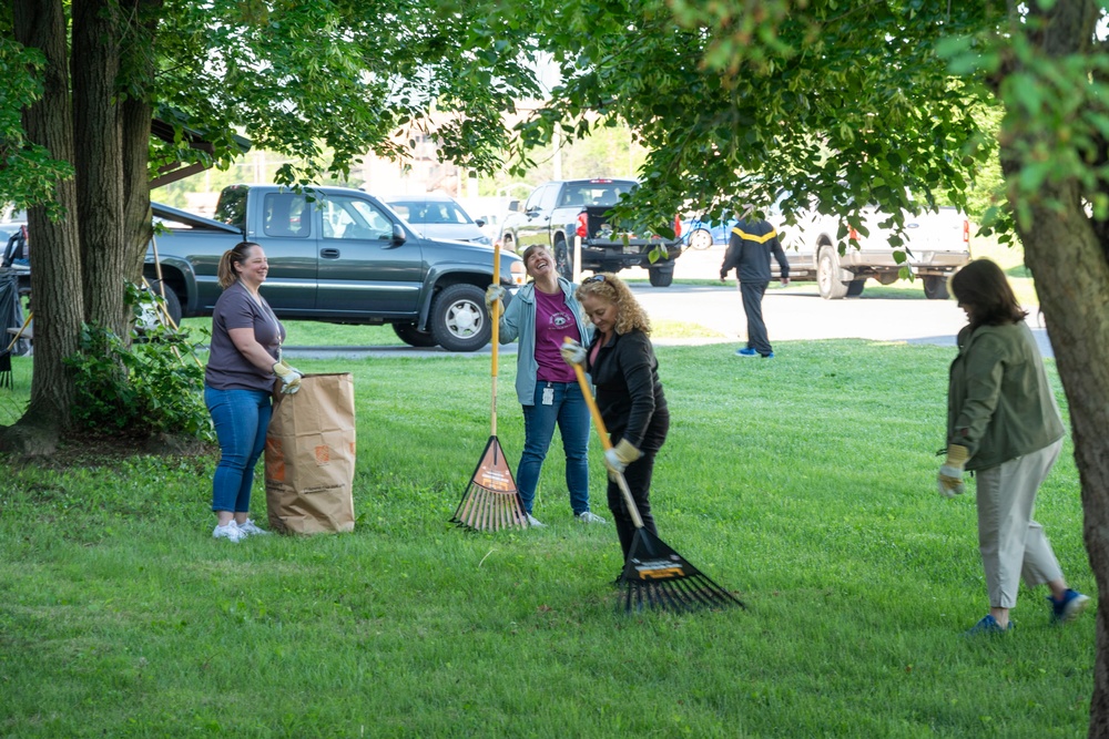 Team members with Operational Medical Systems participate in spring clean-up