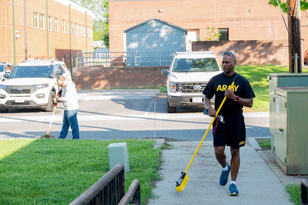 Team members with Operational Medical Systems participate in spring clean-up