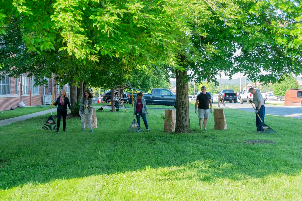 Team members with Operational Medical Systems participate in spring clean-up