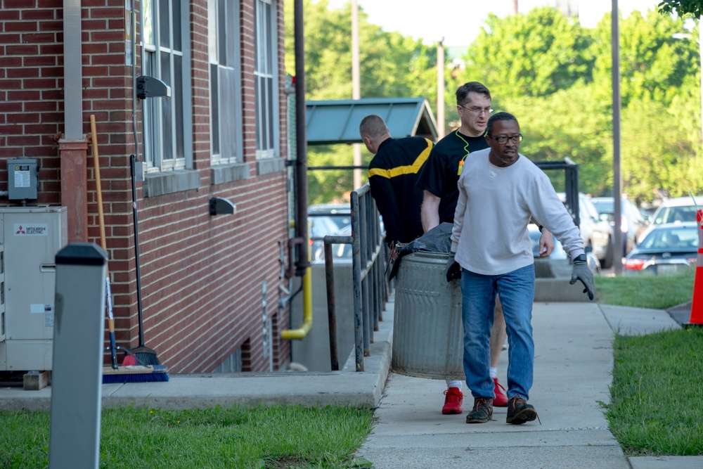 Team members with Operational Medical Systems participate in spring clean-up