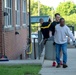 Team members with Operational Medical Systems participate in spring clean-up