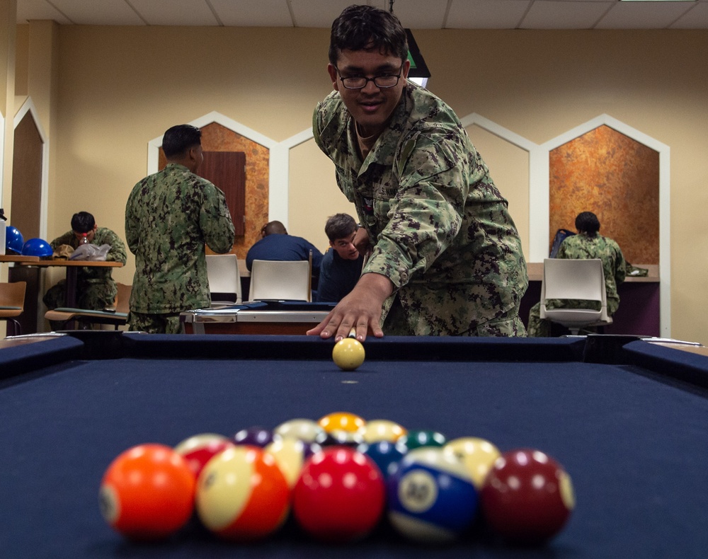 USS John C. Stennis Sailor plays pool