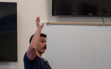 State Fire Fighter, Capt. Abel Cholico, assigned to the 152nd Civil Engineer Squadron's Fire Department, takes questions from children about his job during a base tour at the Nevada Air National Guard Base on May 9, 2025