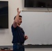 State Fire Fighter, Capt. Abel Cholico, assigned to the 152nd Civil Engineer Squadron's Fire Department, takes questions from children about his job during a base tour at the Nevada Air National Guard Base on May 9, 2025