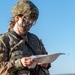 Staff Sgt. Emily Newsome looks at her map