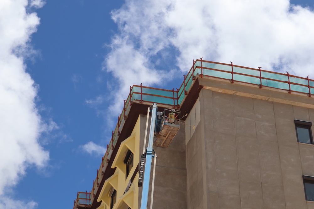 Contractors Apply a Coat of Primer on a New BEQ Building on Camp Blaz.