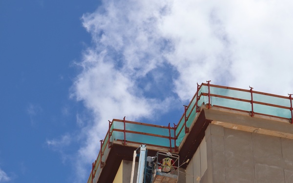 Contractors Apply a Coat of Primer on a New BEQ Building on Camp Blaz.