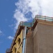 Contractors Apply a Coat of Primer on a New BEQ Building on Camp Blaz.
