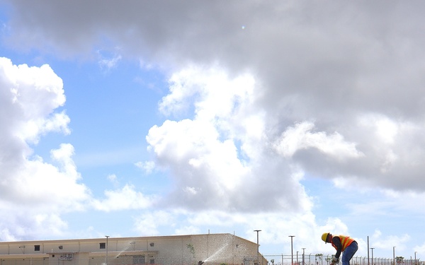 A Contractor Inspects Newly Planted Grass on Marine Corps Base Camp Blaz