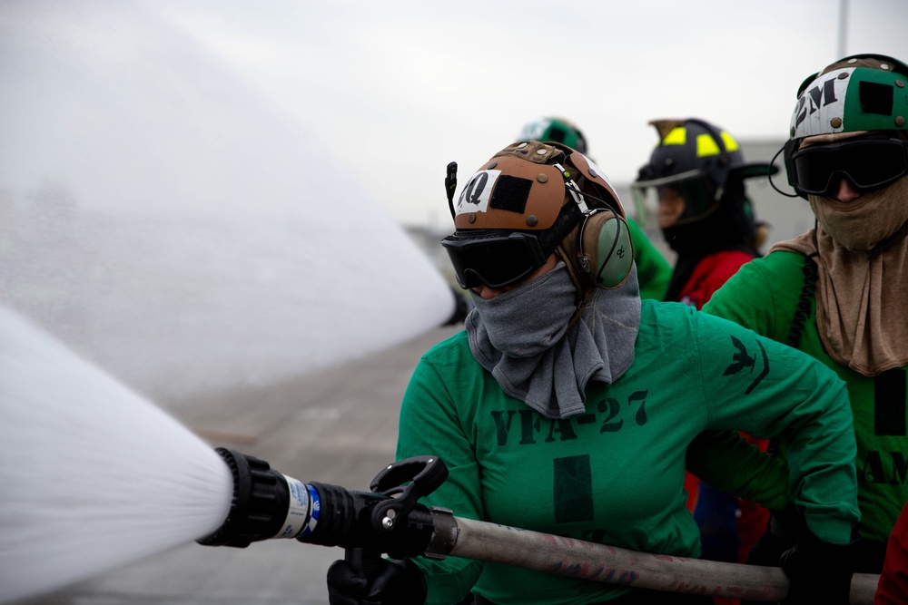 This is fire: U.S. Navy Sailors practice extinguishing fires.