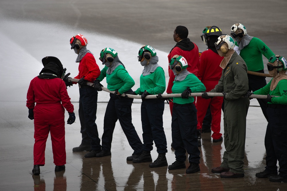 This is fire: U.S. Navy Sailors practice extinguishing fires.