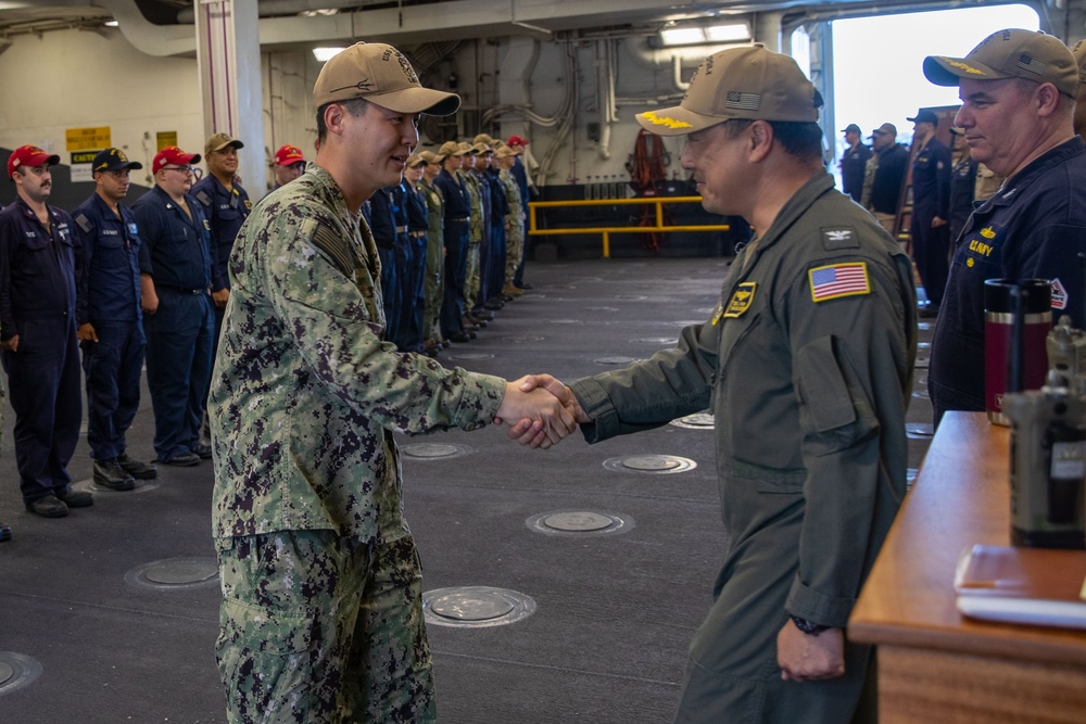USS Tripoli Sailor Lt. j.g Kingmin Lee is Piped Ashore