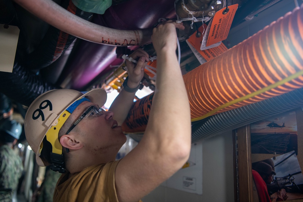 USS Ronald Reagan (CVN 76) Sailors and Puget Sound Naval Shipyard workers secure pipes