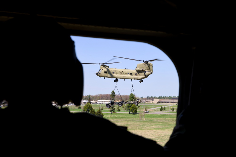 Soldier Observes CH-47 Chinook Lift HMMWV