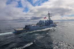 The Arleigh Burke-class guided-missile destroyer USS Thomas Hudner (DDG 116) sails alongside the USS Bulkeley (DDG 84)