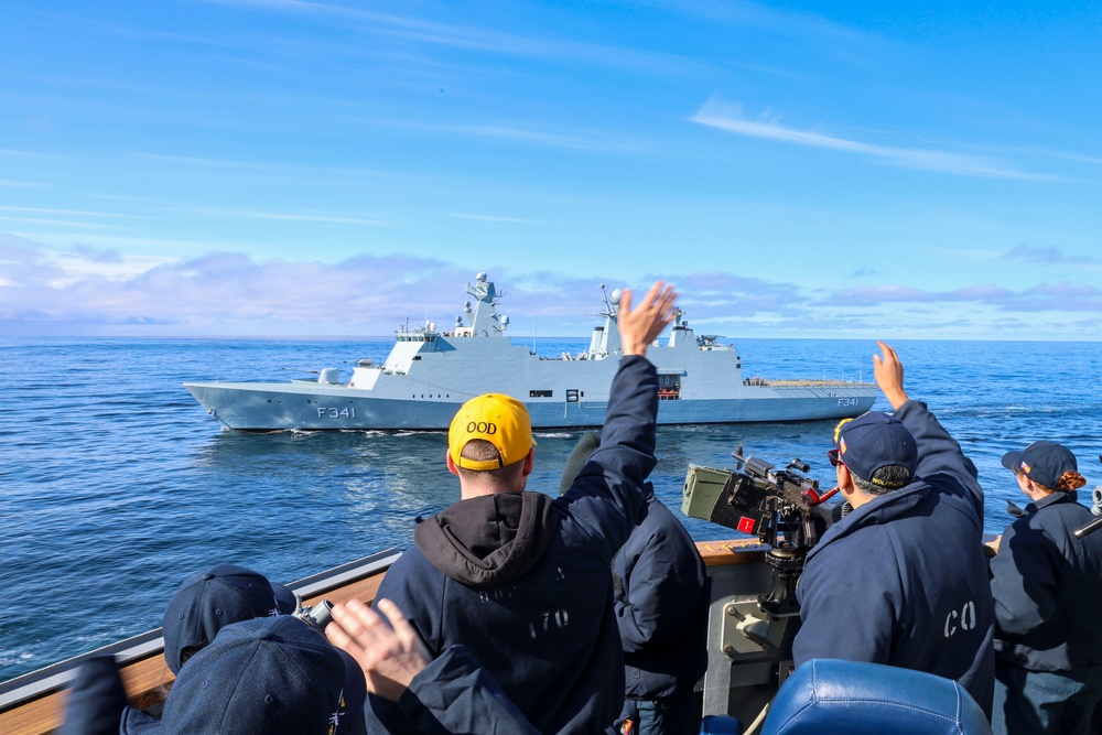 Cmdr. Arturo Trejo and Ensign Jackson Manship wave to the crew of the Royal Danish Navy (RDN) HDMS Absalon (F341)