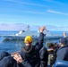 Cmdr. Arturo Trejo and Ensign Jackson Manship wave to the crew of the Royal Danish Navy (RDN) HDMS Absalon (F341)