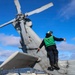 Aviation Machinist’s Mate 2nd Class Keith Gonzales conducts a pre-flight oil servicing check on a MH-60R Sea Hawk helicopter