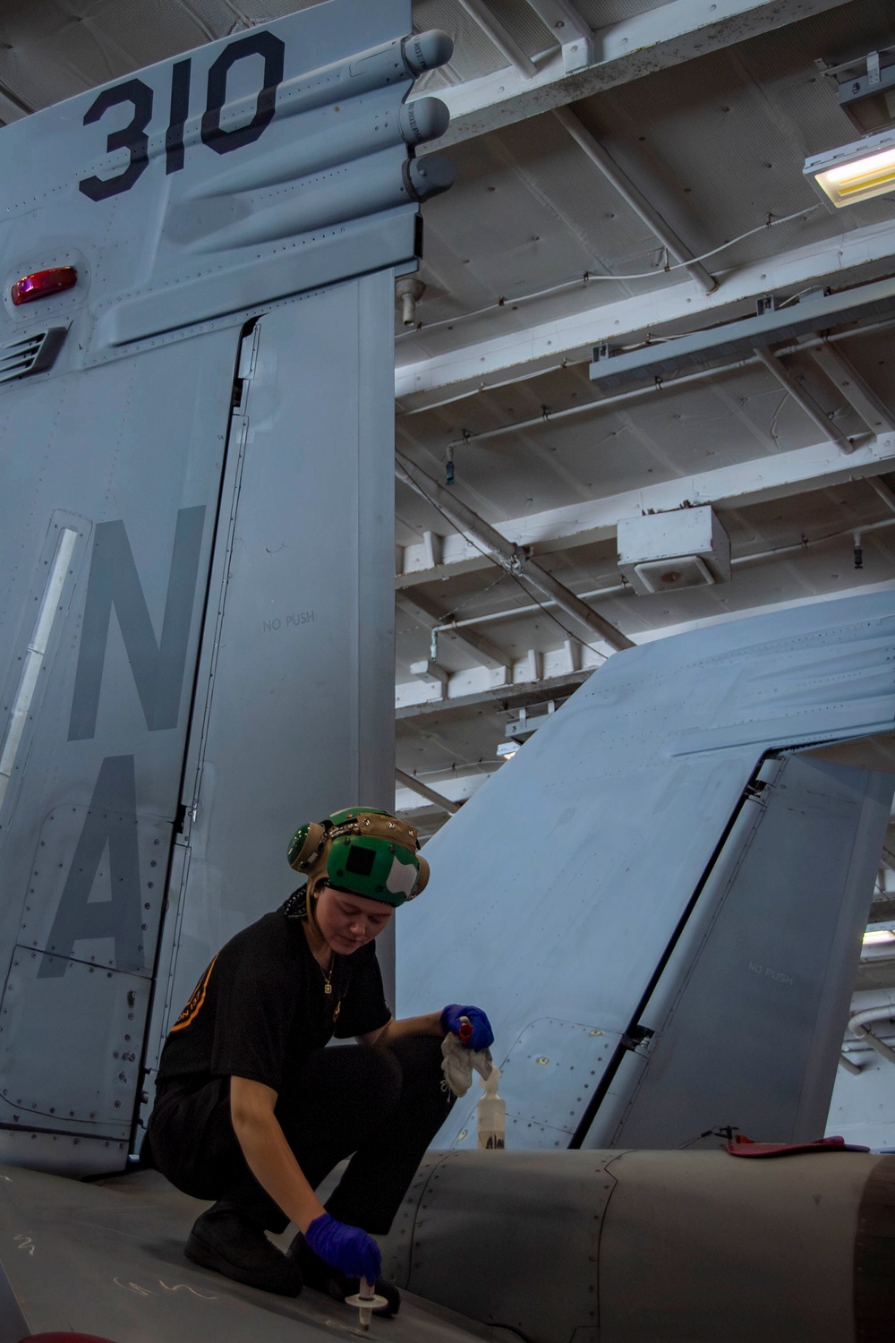 Nimitz Sailor Conducts Maintenance on Aircraft