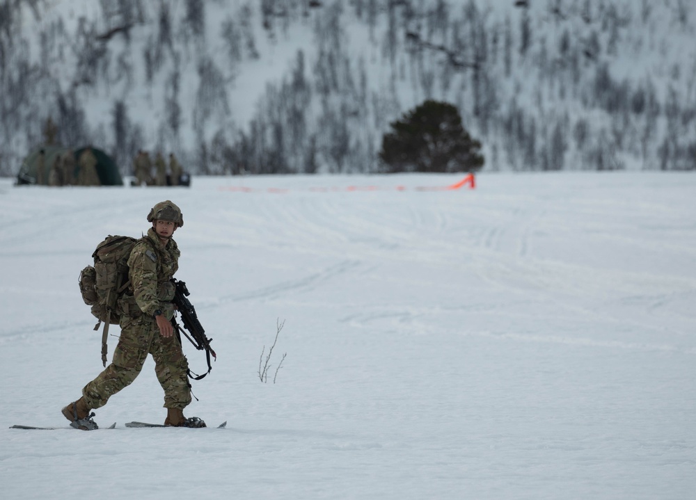 A paratrooper from the 2nd Battalion, 505th Parachute Infantry Regiment, 3rd Brigade Combat Team, 82nd Airborne Division dons his snowshoes and moves toward his objective after safely landing on Liberty Drop Zone, May 13, 2025, during Swift Response 25.