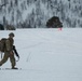 A paratrooper from the 2nd Battalion, 505th Parachute Infantry Regiment, 3rd Brigade Combat Team, 82nd Airborne Division dons his snowshoes and moves toward his objective after safely landing on Liberty Drop Zone, May 13, 2025, during Swift Response 25.