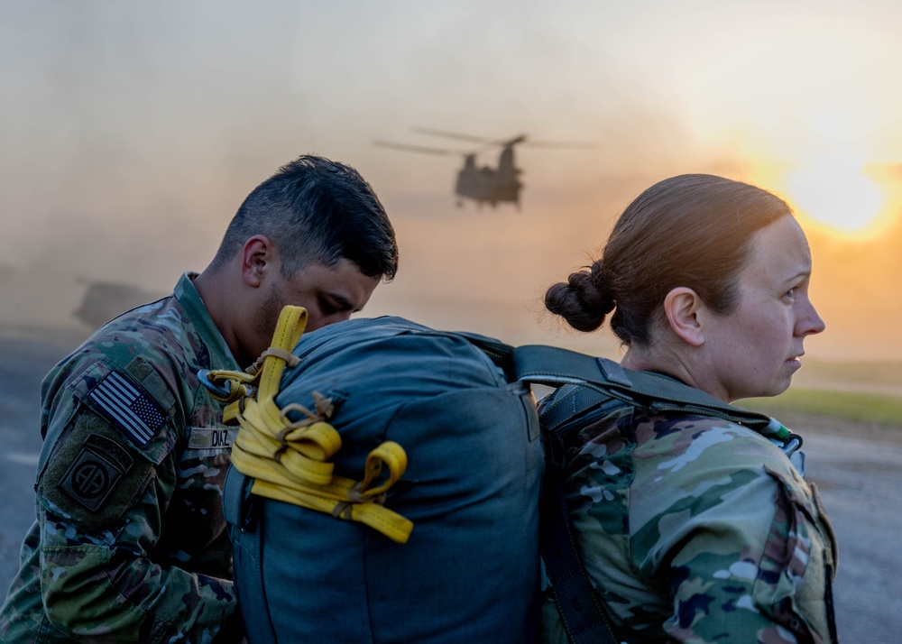Soldiers from 82nd Airborne Division jump from a CH-47 Chinook to earn their foreign wings