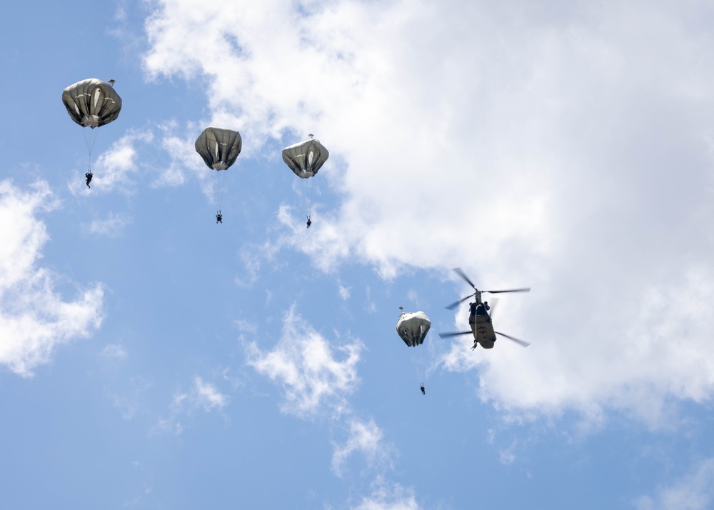 Soldiers from 82nd Airborne Division jump from a CH-47 Chinook to earn their foreign wings