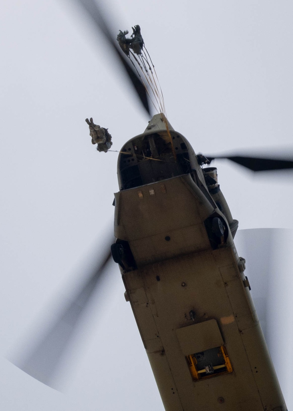 Soldiers from 82nd Airborne Division jump from a CH-47 Chinook to earn their foreign wings