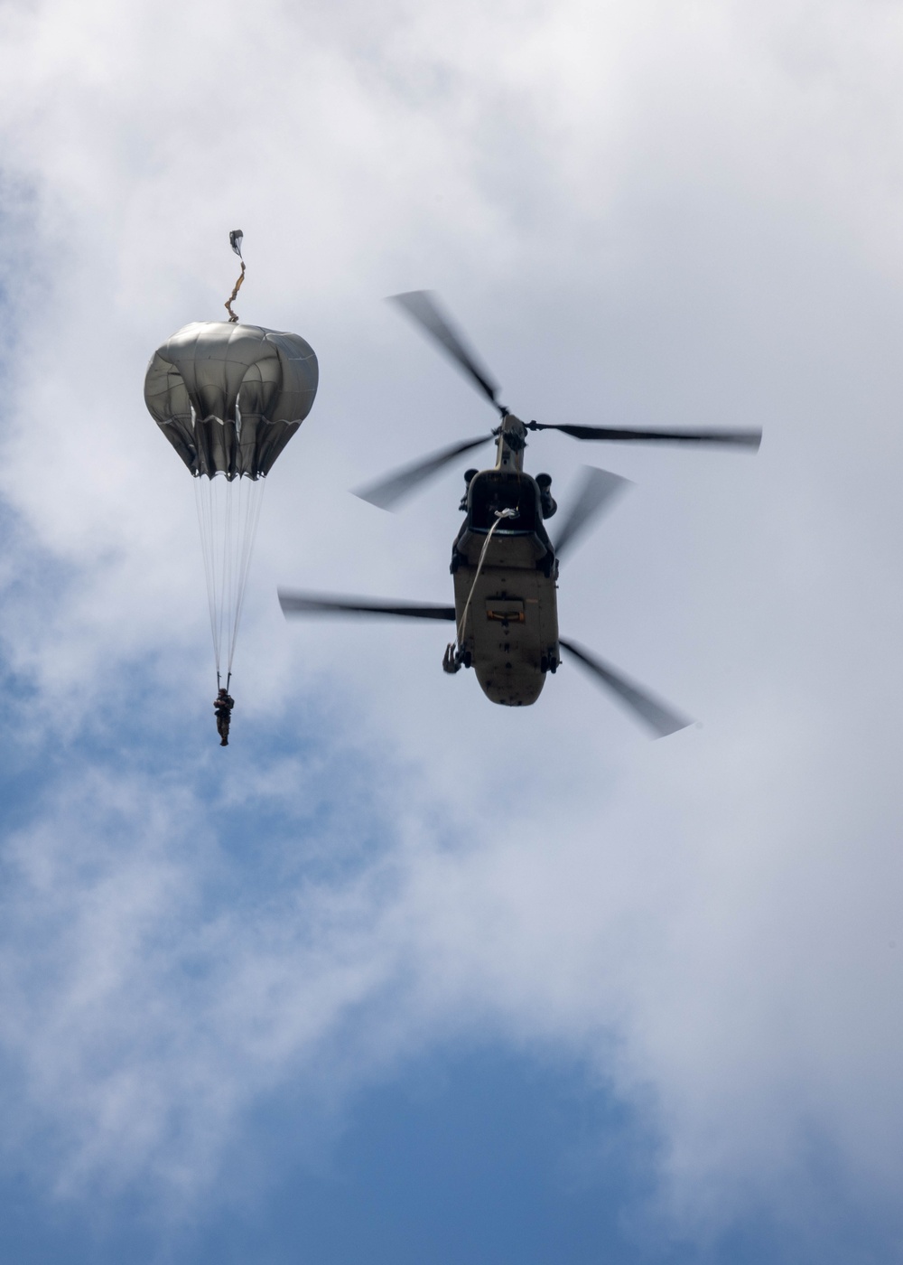 Soldiers from 82nd Airborne Division jump from a CH-47 Chinook to earn their foreign wings