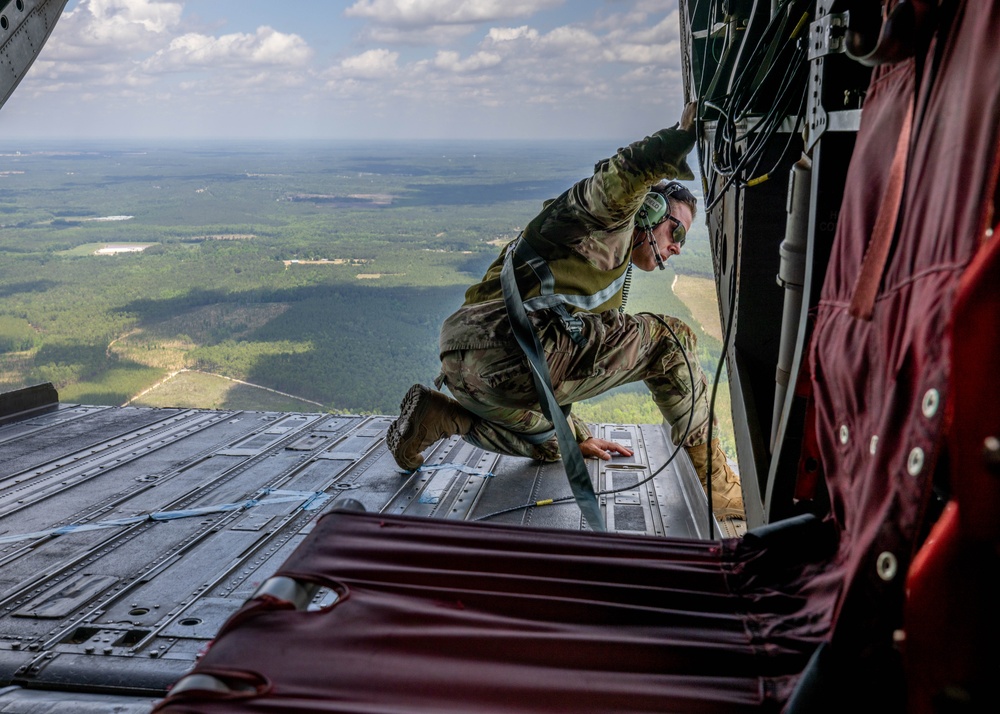 Soldiers from 82nd Airborne Division jump from a CH-47 Chinook to earn their foreign wings