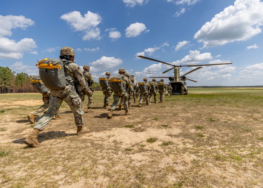 Soldiers from 82nd Airborne Division jump from a CH-47 Chinook to earn their foreign wings
