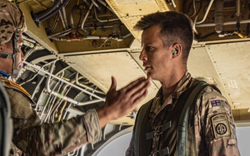 Soldiers from 82nd Airborne Division jump from a CH-47 Chinook to earn their foreign wings