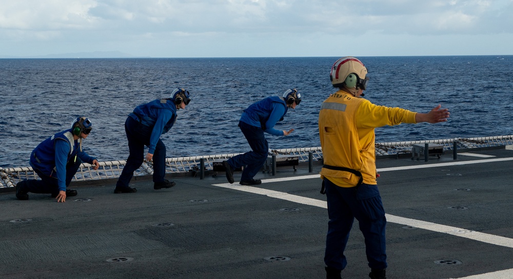U.S. Coast Guard Cutter Stratton crew train with a Navy MH-60R Seahawk helicopter crew from Andersen Air Force Base on the Pacific Ocean near Guam