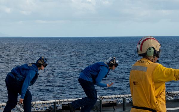 U.S. Coast Guard Cutter Stratton crew train with a Navy MH-60S Seahawk helicopter crew from Andersen Air Force Base on the Pacific Ocean near Guam