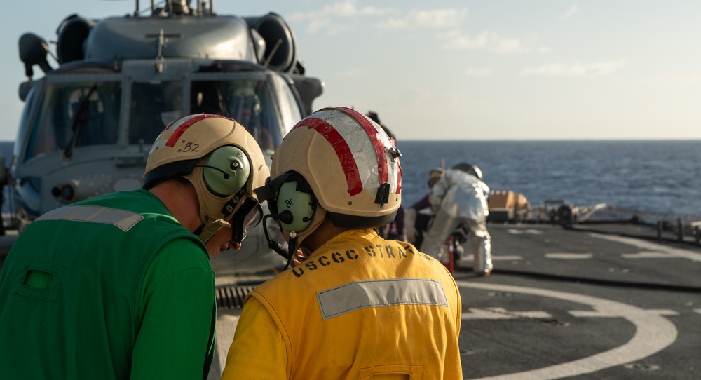 U.S. Coast Guard Cutter Stratton crew train with a Navy MH-60R Seahawk helicopter crew from Andersen Air Force Base on the Pacific Ocean near Guam