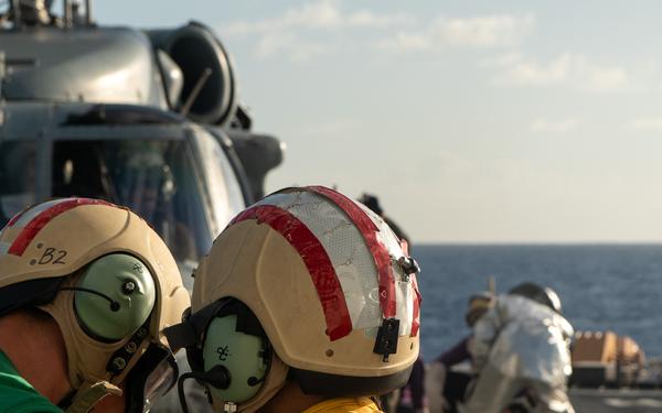 U.S. Coast Guard Cutter Stratton crew train with a Navy MH-60S Seahawk helicopter crew from Andersen Air Force Base on the Pacific Ocean near Guam